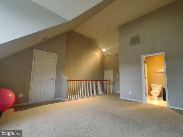 additional living space with carpet flooring and vaulted ceiling