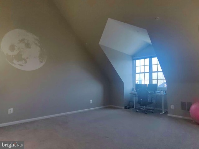 bonus room featuring vaulted ceiling and carpet