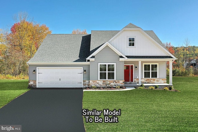 view of front of house with a garage and a front lawn