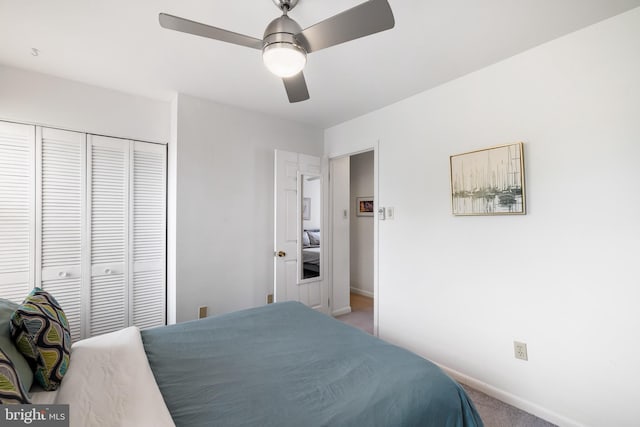 carpeted bedroom with a closet and ceiling fan