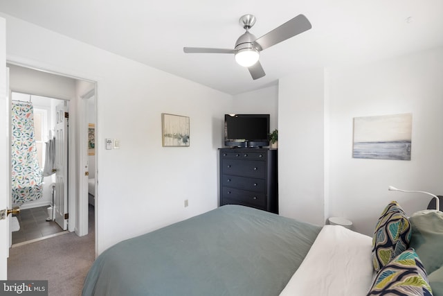 bedroom featuring ceiling fan, ensuite bath, and light carpet