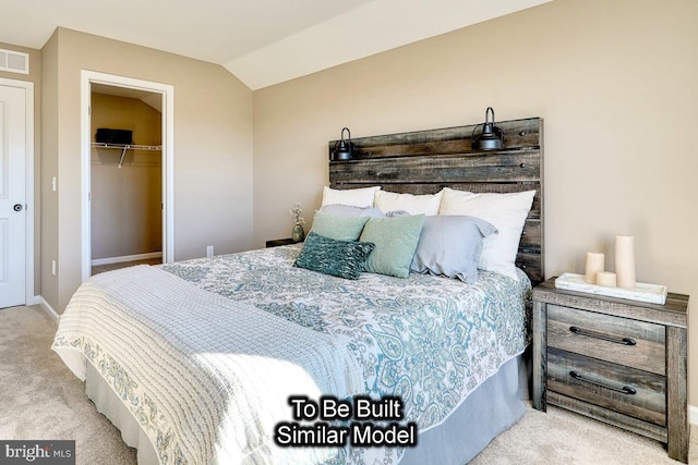 carpeted bedroom featuring a spacious closet, vaulted ceiling, and a closet