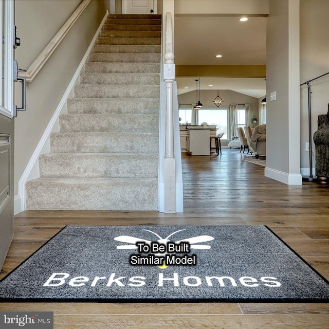 stairs featuring hardwood / wood-style floors