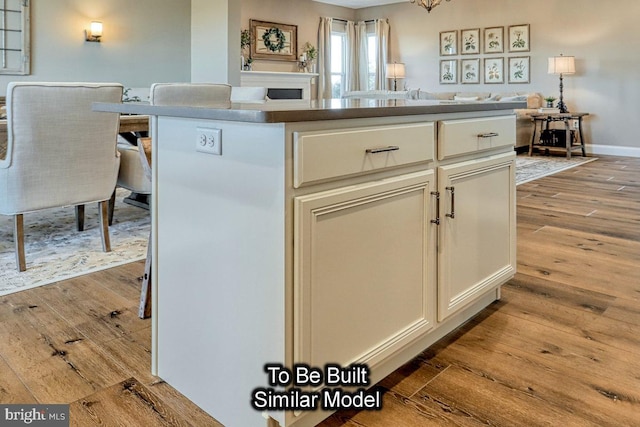 kitchen featuring light hardwood / wood-style flooring, white cabinets, and a center island