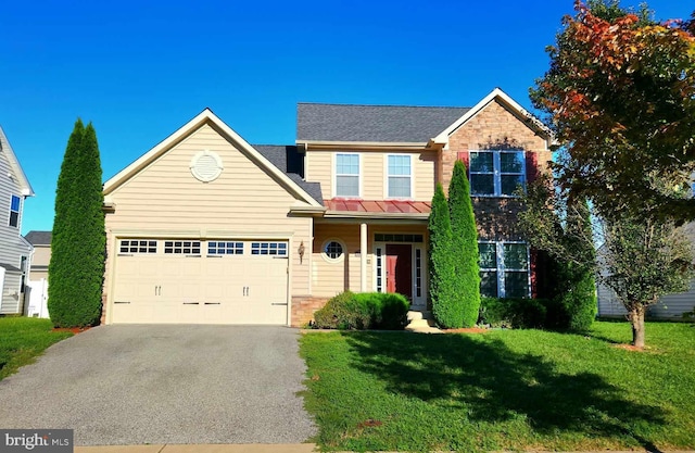 traditional home with stone siding, driveway, an attached garage, and a front yard