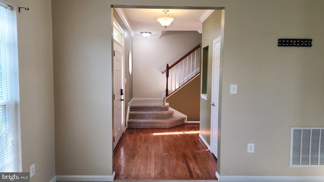 interior space featuring wood-type flooring and ornamental molding