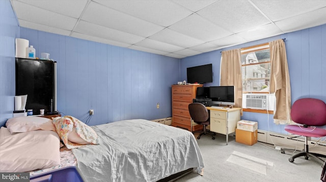 carpeted bedroom with baseboard heating, a paneled ceiling, and cooling unit