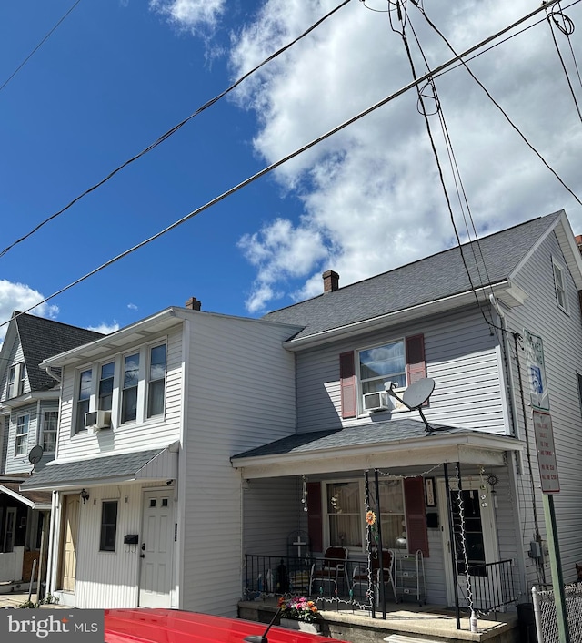 view of front of house with cooling unit and a porch