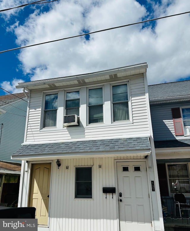 multi unit property with cooling unit and a shingled roof