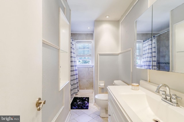 bathroom with vanity, toilet, walk in shower, and tile patterned flooring