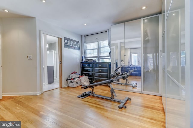 workout room with light hardwood / wood-style flooring