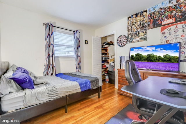 bedroom with a closet and hardwood / wood-style floors