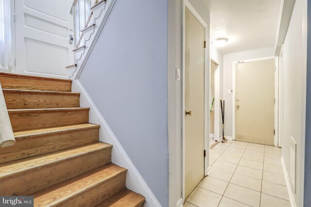 staircase with tile patterned floors