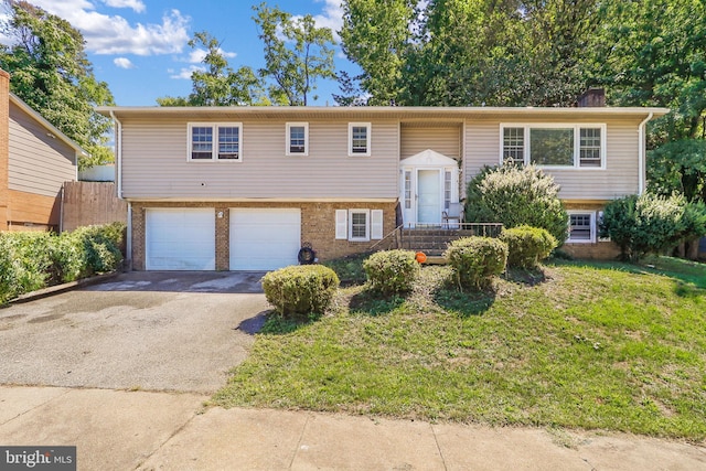 bi-level home with a front yard and a garage