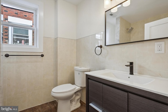 bathroom featuring tile walls, vanity, wood-type flooring, and toilet