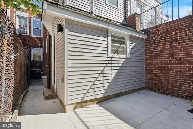 view of property exterior with a patio area