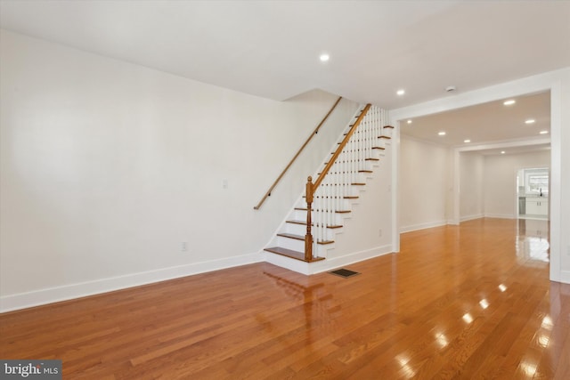 interior space with recessed lighting, stairway, baseboards, and light wood finished floors