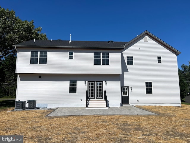 rear view of property featuring cooling unit and a patio area