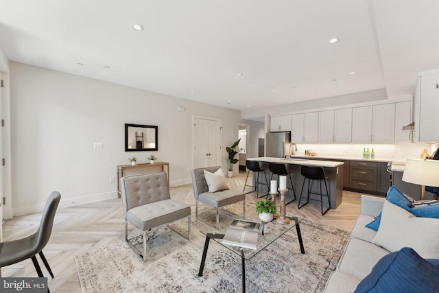 living room with light parquet flooring and sink