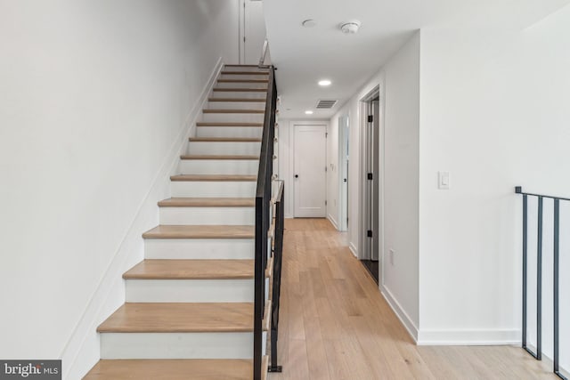 staircase with wood-type flooring