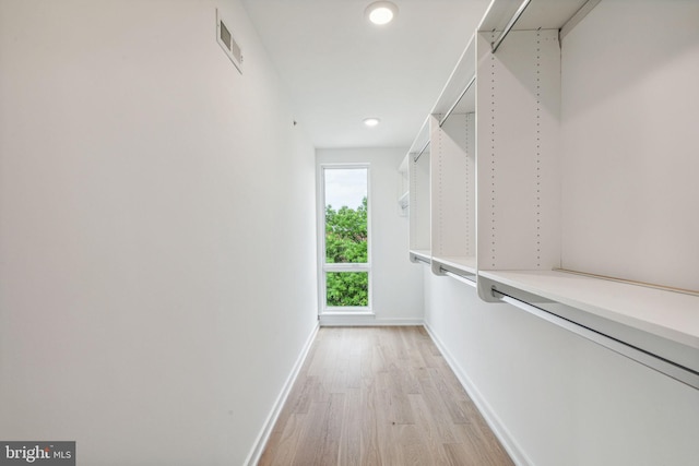 spacious closet featuring light hardwood / wood-style flooring