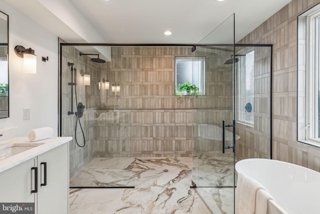 bathroom featuring separate shower and tub and vanity