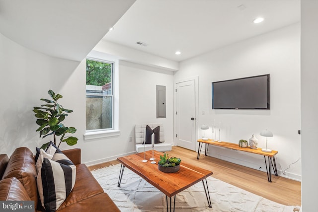 living room featuring electric panel and light wood-type flooring