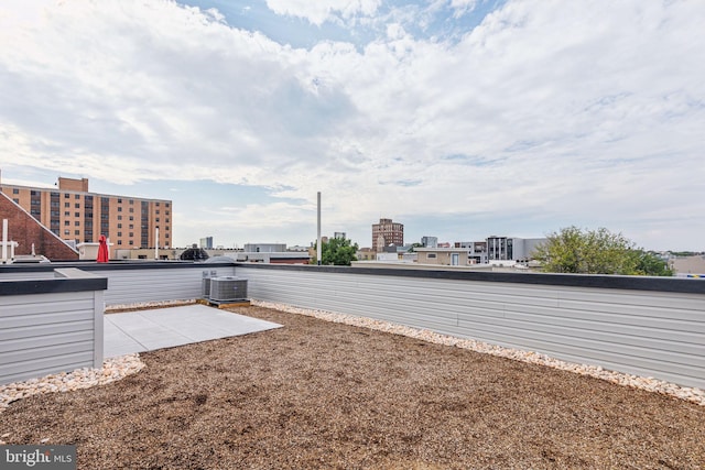 view of yard featuring central air condition unit and a patio