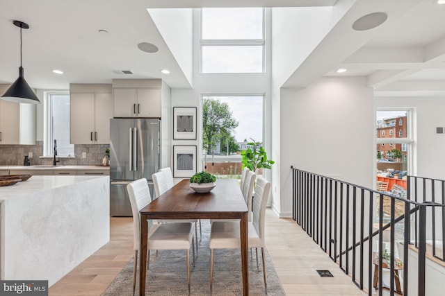 dining room with sink and light hardwood / wood-style floors