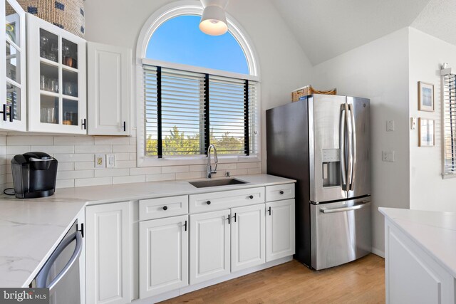 kitchen featuring light wood-type flooring, white cabinetry, sink, and stainless steel appliances