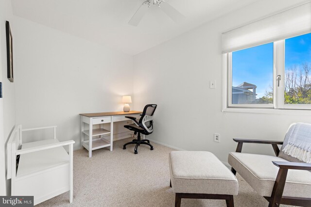 office space featuring light carpet and ceiling fan