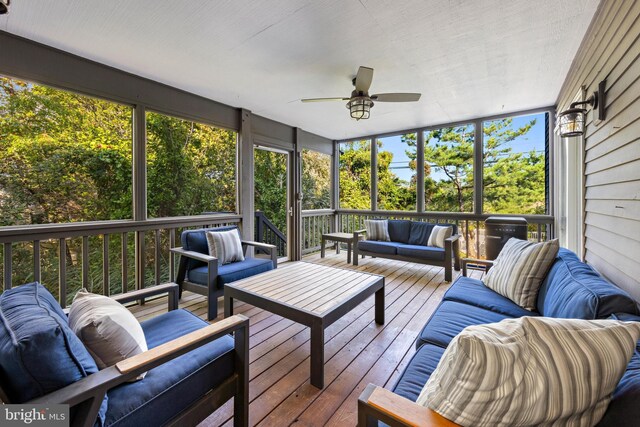 sunroom / solarium with a wealth of natural light and ceiling fan