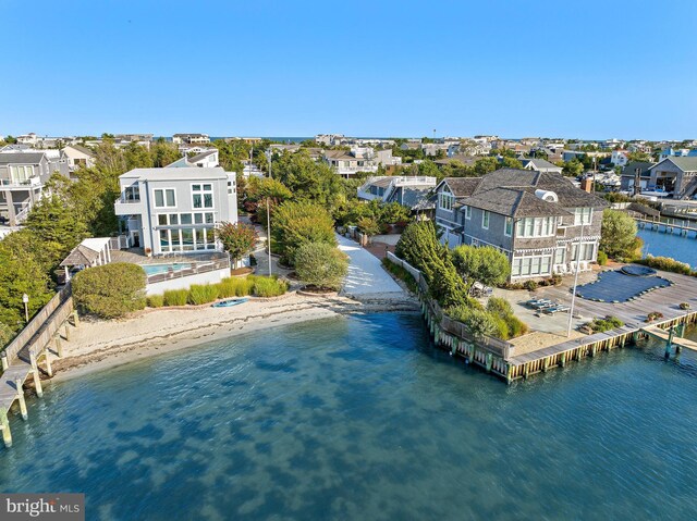 drone / aerial view featuring a water view and a view of the beach