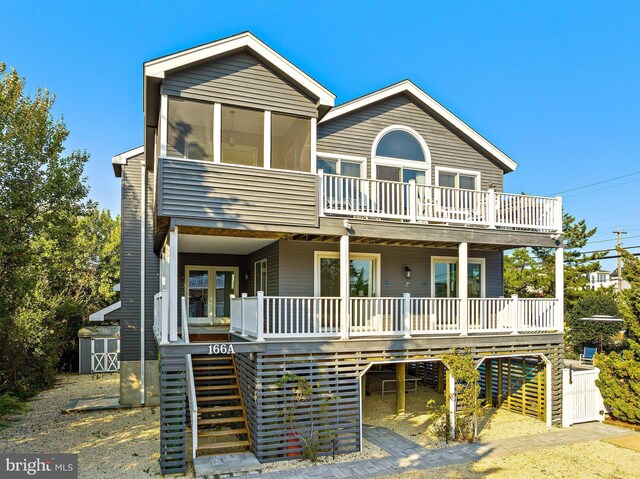 coastal home with a storage shed and a porch