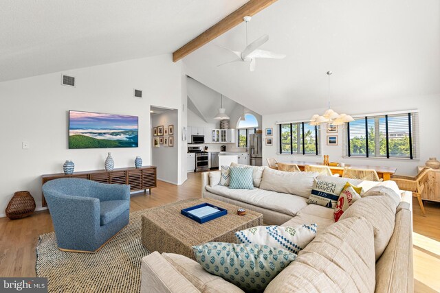 living room with high vaulted ceiling, hardwood / wood-style floors, beamed ceiling, and a notable chandelier