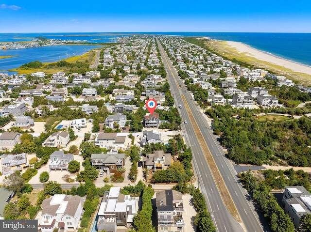 drone / aerial view with a water view and a view of the beach