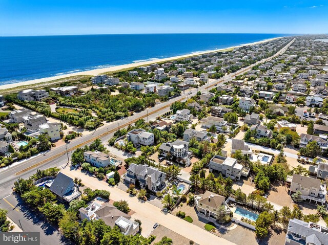 bird's eye view featuring a water view and a view of the beach