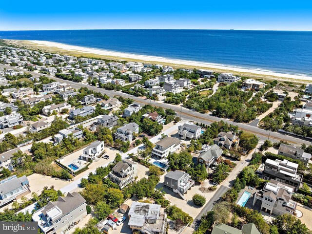 bird's eye view featuring a water view and a view of the beach