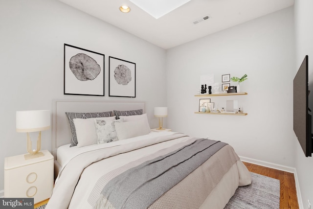 bedroom with hardwood / wood-style flooring