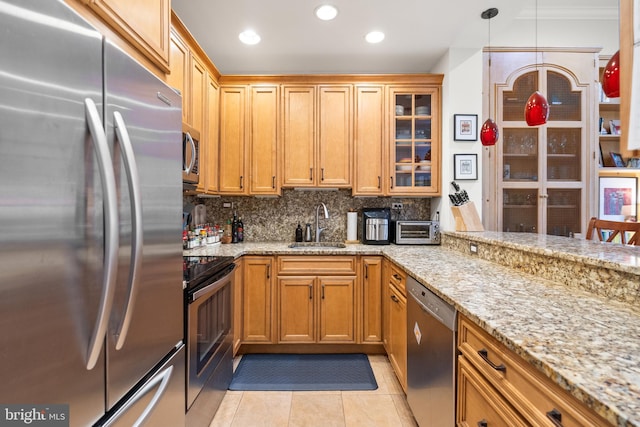 kitchen featuring crown molding, sink, light stone countertops, decorative backsplash, and appliances with stainless steel finishes