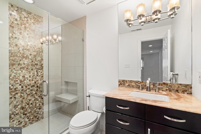 bathroom with vanity, toilet, and an enclosed shower