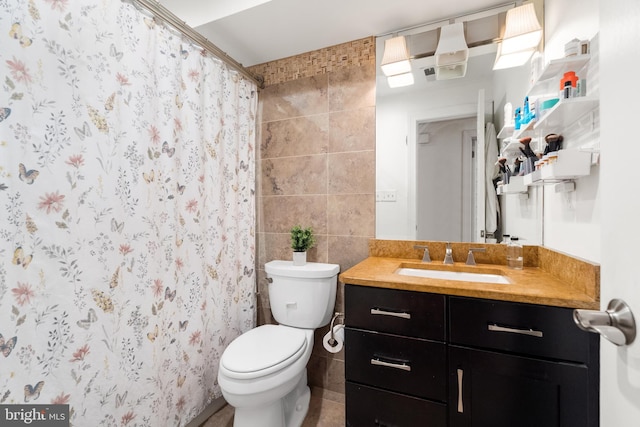 bathroom with tile walls, walk in shower, toilet, and vanity