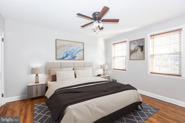 bedroom with ceiling fan and dark hardwood / wood-style flooring