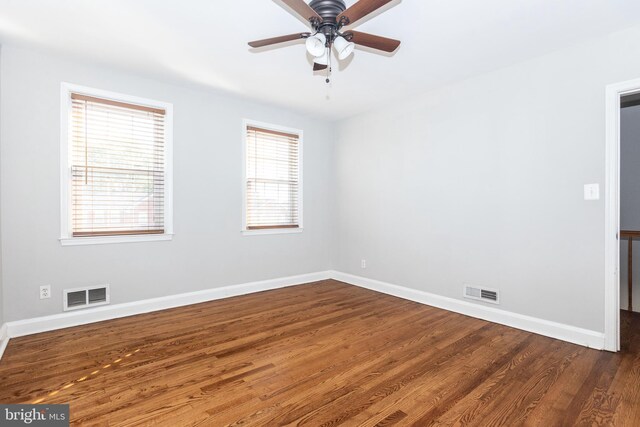 unfurnished room featuring ceiling fan and dark hardwood / wood-style floors