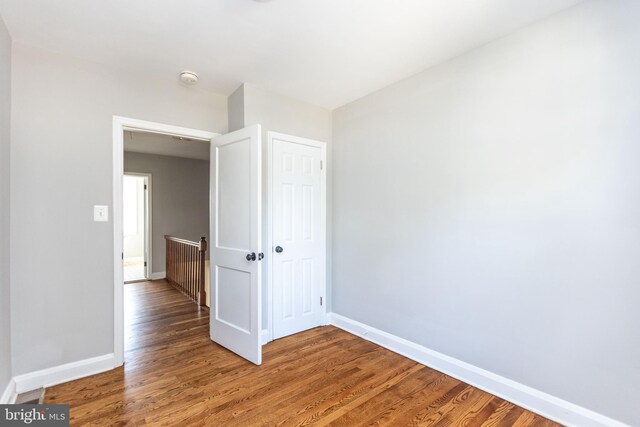 empty room with hardwood / wood-style flooring