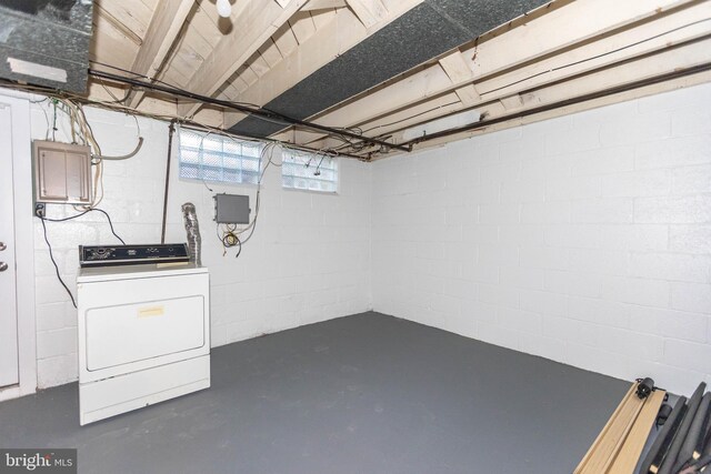 basement with electric panel and washer / dryer