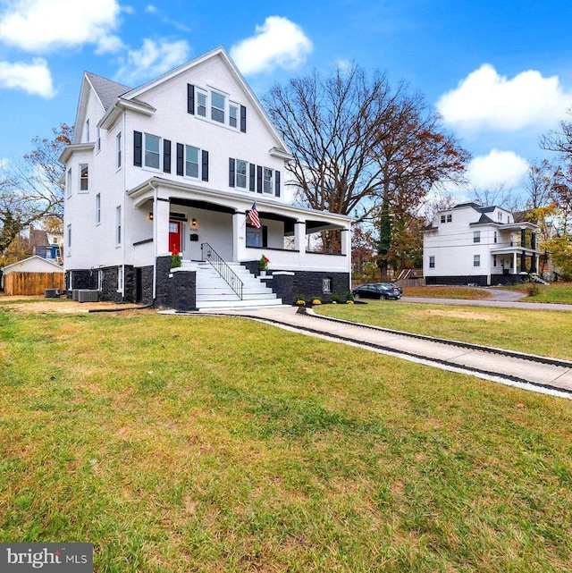 view of front facade with a front lawn and a porch