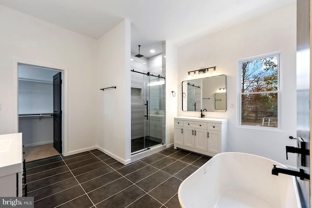 bathroom featuring shower with separate bathtub, vanity, and tile patterned floors