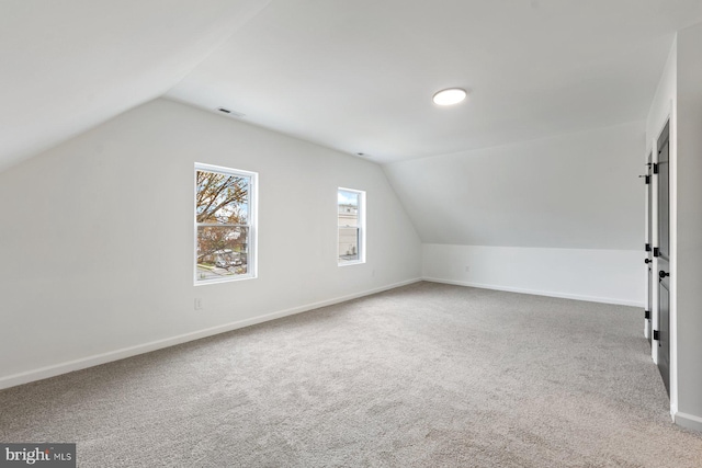 bonus room featuring carpet flooring and vaulted ceiling