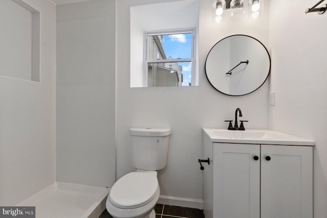 bathroom featuring tile patterned flooring, vanity, and toilet